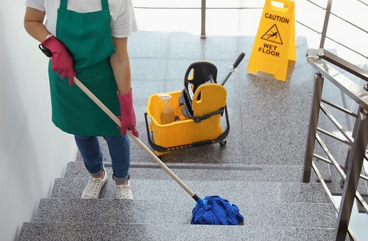 janitorial services cleaning floor with mop